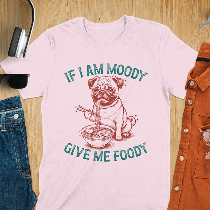 Light pink t-shirt with pug eating ramen with chopsticks graphic featuring 'If I Am Moody Give Me Foody' text - funny dog meme design