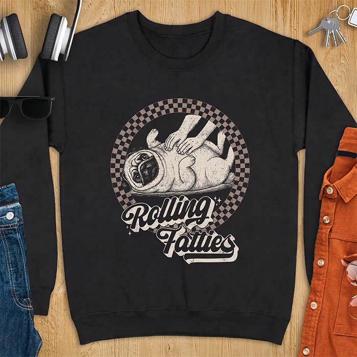 Black sweatshirt with a graphic of a pug lying on its back inside a checkered circle while a pair of hands press into its rolled folds and the text Rolling Fatties