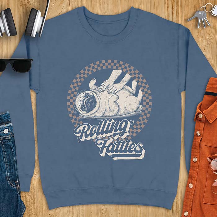 Indigo Blue sweatshirt with a graphic of a pug lying on its back inside a checkered circle while a pair of hands press into its rolled folds and the text Rolling Fatties