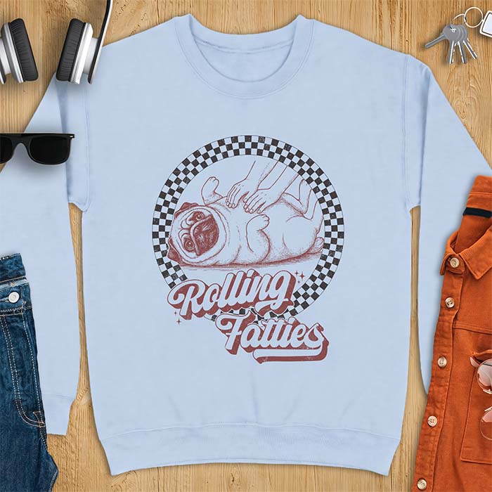 Light Blue sweatshirt with a graphic of a pug lying on its back inside a checkered circle while a pair of hands press into its rolled folds and the text Rolling Fatties