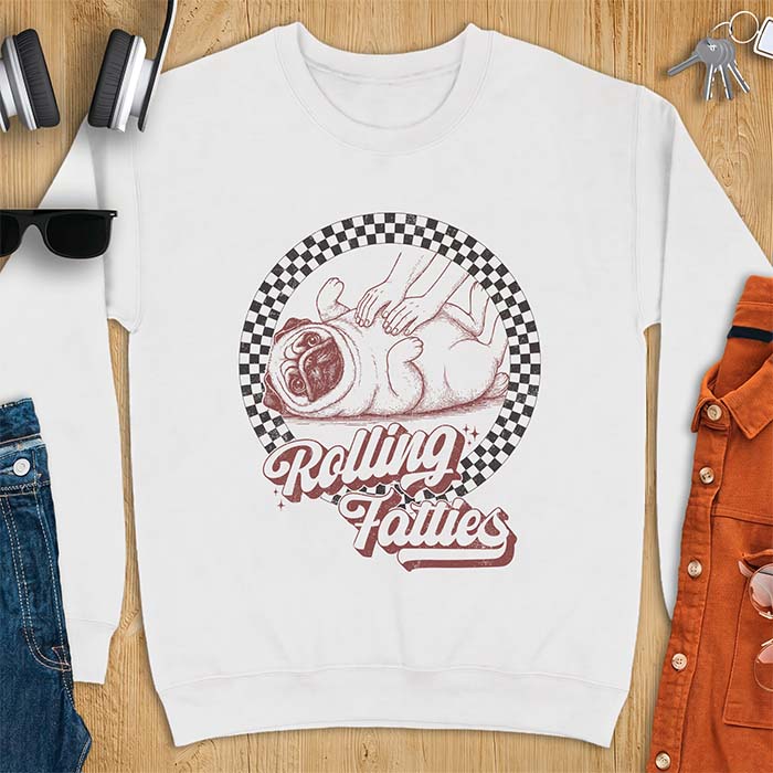 White sweatshirt with a graphic of a pug lying on its back inside a checkered circle while a pair of hands press into its rolled folds and the text Rolling Fatties