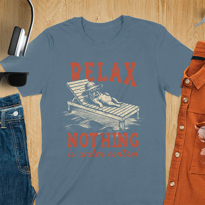 Indigo blue t-shirt featuring a bulldog wearing a straw hat lounging on a beach chair with text Relax Nothing Is Under Control in vintage red lettering