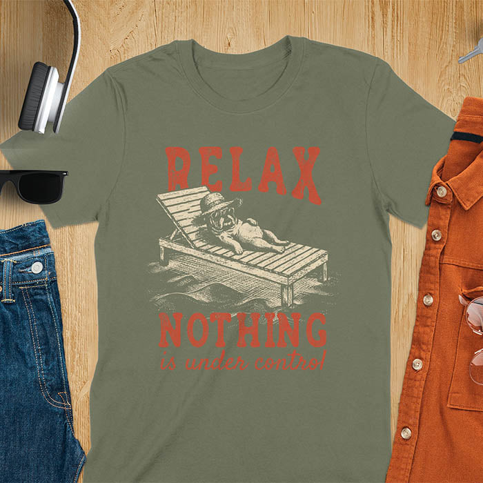 Military green t-shirt featuring a bulldog wearing a straw hat lounging on a beach chair with text Relax Nothing Is Under Control in vintage red lettering