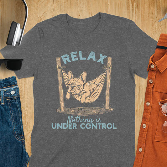 Dark heather t-shirt with vintage-inspired illustration. Retro graphic features French bulldog relaxing in hammock with 'Relax' and 'Nothing is Under Control' text in distressed typography. Quirky zen humor meme design.