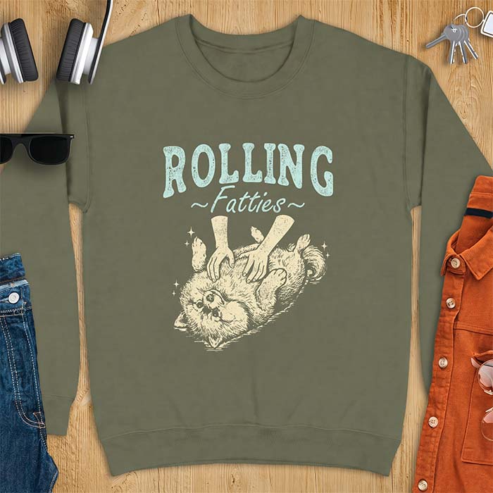Military Green sweatshirt with a graphic of a fluffy Pomeranian rolled onto its back getting a belly rub from two hands and the text Rolling Fatties