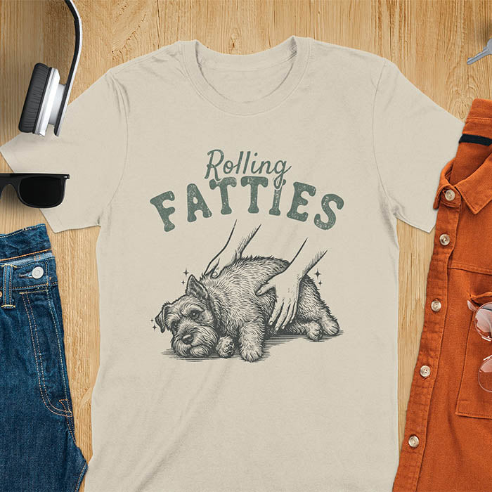 Sand color t-shirt with Rolling Fatties text and chubby Schnauzer getting belly rubs illustration