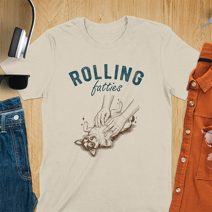 Light blue t-shirt featuring chubby chihuahua lying on back getting belly rubs from a pair of hands, text reads Rolling Fatties