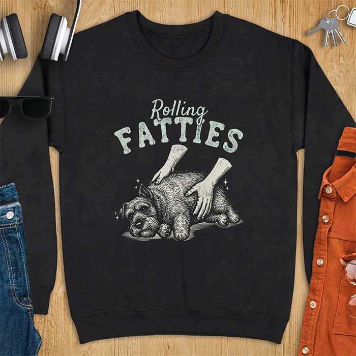 Black sweatshirt with a graphic of a scruffy Schnauzer lying curled on the ground while two hands reach in to scratch and pet it, plus the text Rolling Fatties above.
