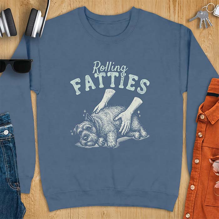 Indigo Blue sweatshirt with a graphic of a scruffy Schnauzer lying curled on the ground while two hands reach in to scratch and pet it, plus the text Rolling Fatties above.