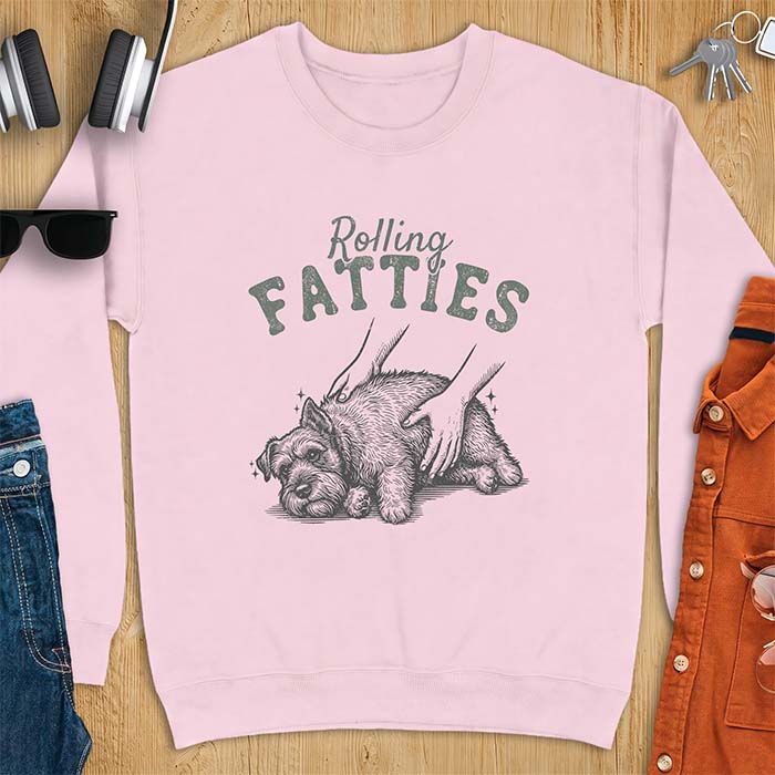 Light Pink sweatshirt with a graphic of a scruffy Schnauzer lying curled on the ground while two hands reach in to scratch and pet it, plus the text Rolling Fatties above.