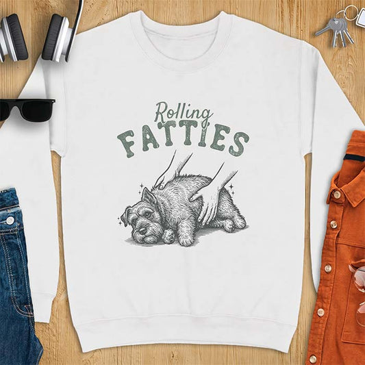 White sweatshirt with a graphic of a scruffy Schnauzer lying curled on the ground while two hands reach in to scratch and pet it, plus the text Rolling Fatties above.