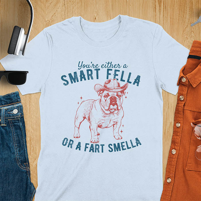 Smart Fella or Fart Smella vintage 90s meme t-shirt with English bulldog wearing cowboy hat on light blue tee