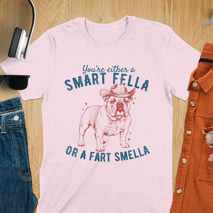 Smart Fella or Fart Smella vintage 90s meme t-shirt with English bulldog wearing cowboy hat on light pink tee
