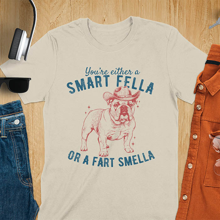 Smart Fella or Fart Smella vintage 90s meme t-shirt with English bulldog wearing cowboy hat on sand color tee