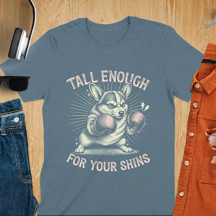Indigo blue graphic tee with retro illustration of a corgi wearing boxing gloves, text reads Tall Enough For Your Shins