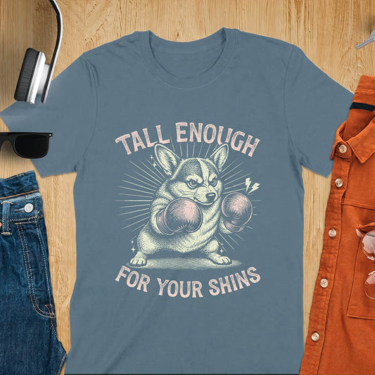 Indigo blue graphic tee with retro illustration of a corgi wearing boxing gloves, text reads Tall Enough For Your Shins