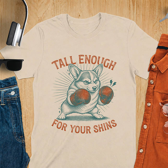 Sand color graphic tee with retro illustration of a corgi wearing boxing gloves, text reads Tall Enough For Your Shins