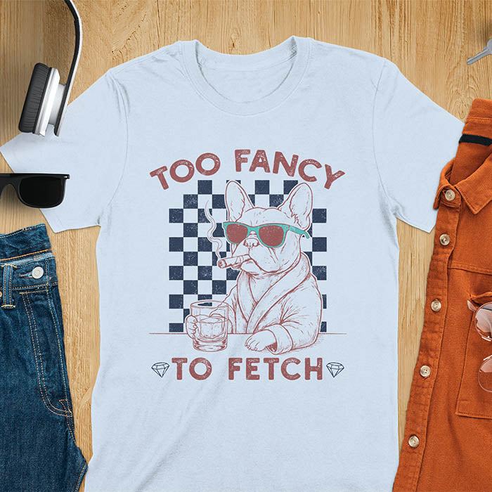Light blue tee with "Too Fancy To Fetch" text and French Bulldog in sunglasses with whisky and smoking cigar on checkered background