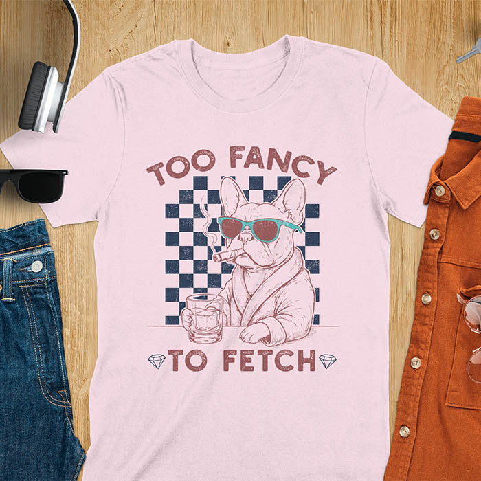 Light pink tee with "Too Fancy To Fetch" text and French Bulldog in sunglasses with whisky and smoking cigar on checkered background