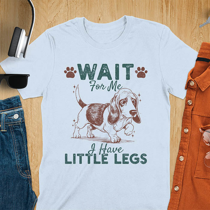 Basset hound meme t-shirt with dog illustration and text Wait For Me I Have Little Legs with paw prints - light blue