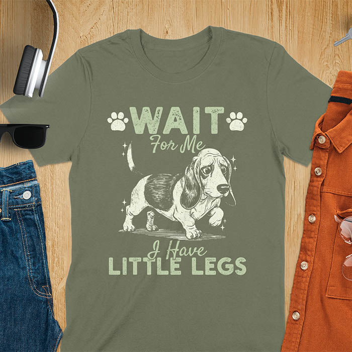 Basset hound meme t-shirt with dog illustration and text Wait For Me I Have Little Legs with paw prints - military green
