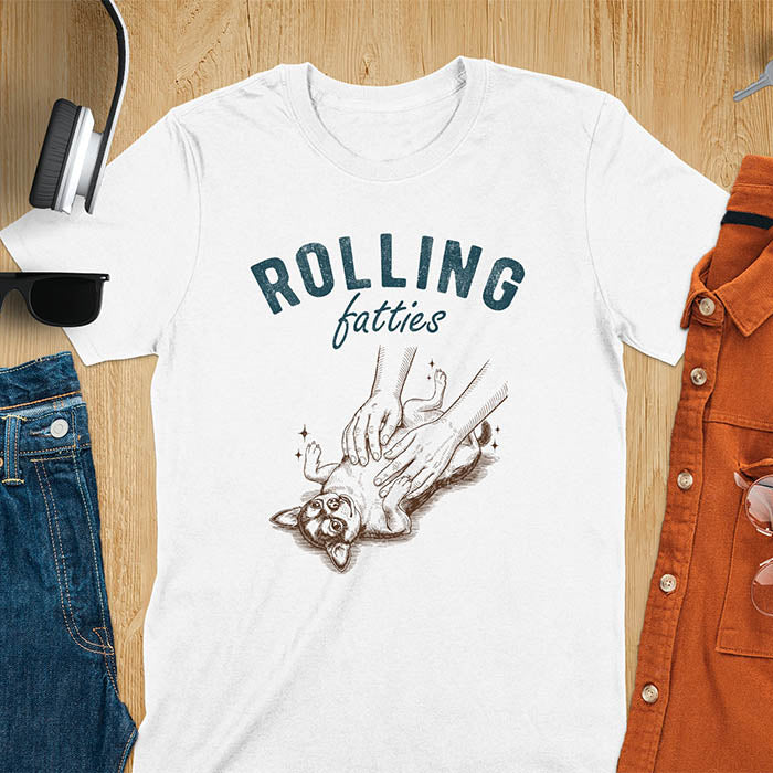 White t-shirt featuring chubby chihuahua lying on back getting belly rubs from a pair of hands, text reads Rolling Fatties