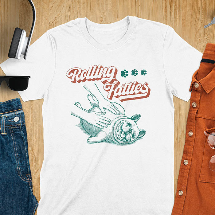 White t-shirt with Rolling Fatties script text and French Bulldog being petted by human hands in line drawing style.