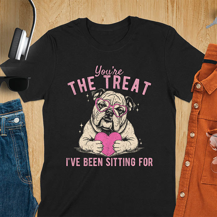 You're the treat I've been sitting for bulldog with pink heart glasses holding pink heart graphic tee on black shirt