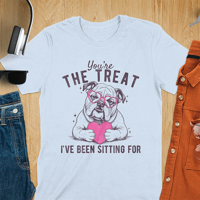You're the treat I've been sitting for bulldog with pink heart glasses holding pink heart graphic tee on light blue shirt